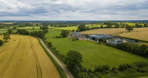 Farmer and rural property adviser reviewing plans for farmland funded by an agricultural bridging loan